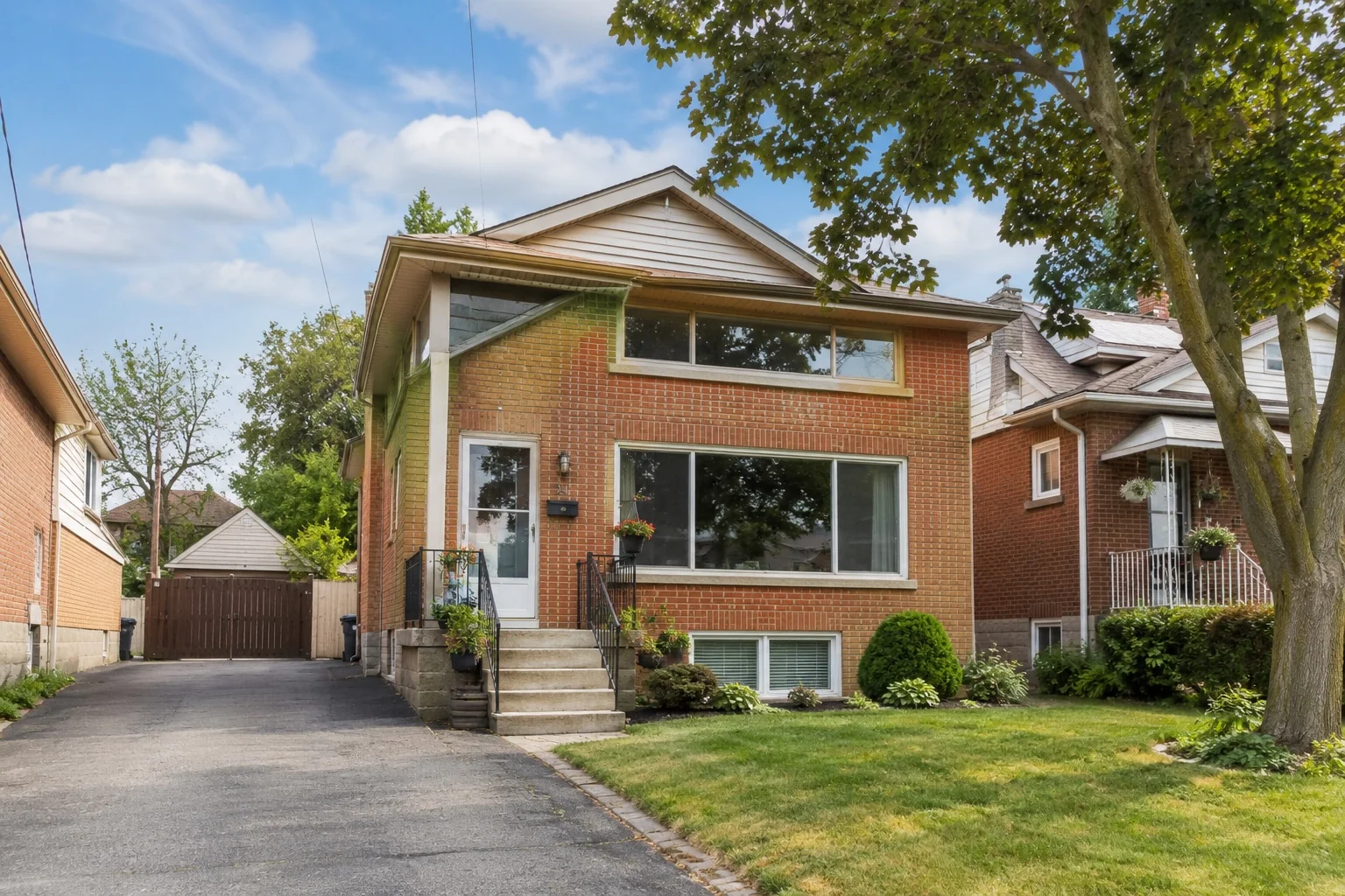 Detached brick home with multiple window types in Etobicoke