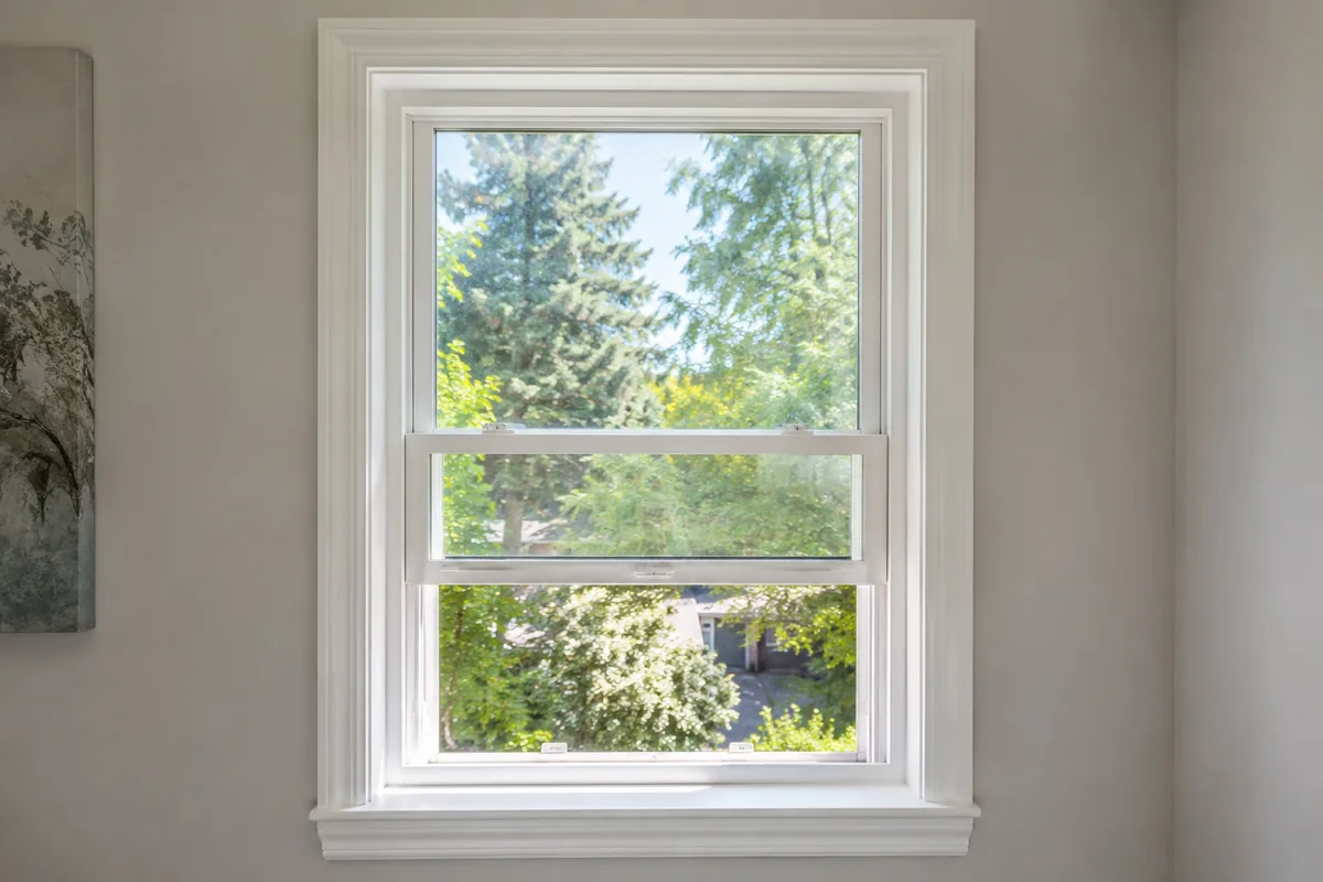 Installed residential single-hung window with raised lower sash